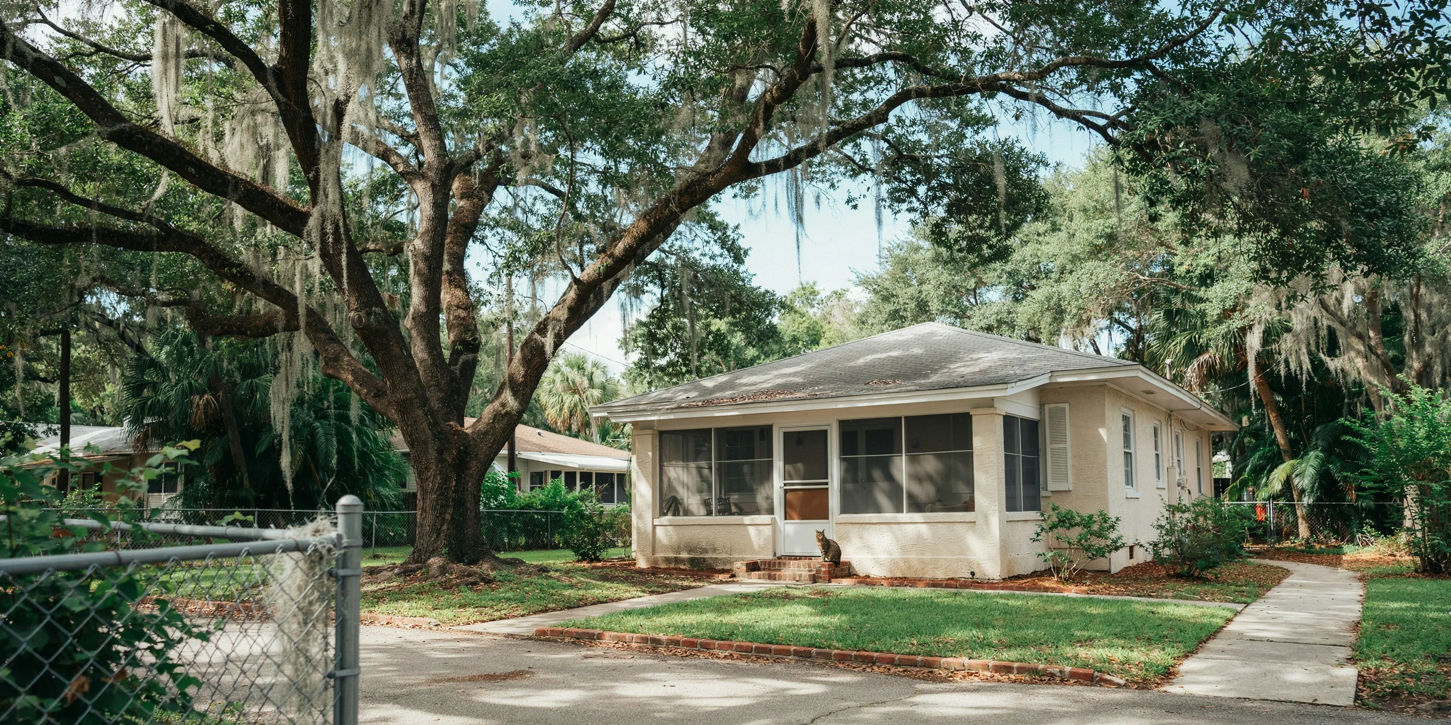 Home with screened porch under live oaks at The Oaks, Osprey, FL